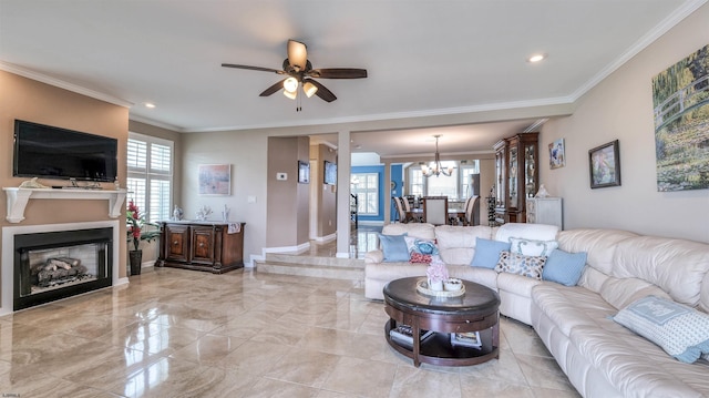 living room with a chandelier, healthy amount of natural light, ornamental molding, ceiling fan, and a fireplace