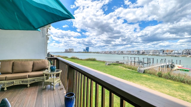 balcony featuring a water view and outdoor lounge area