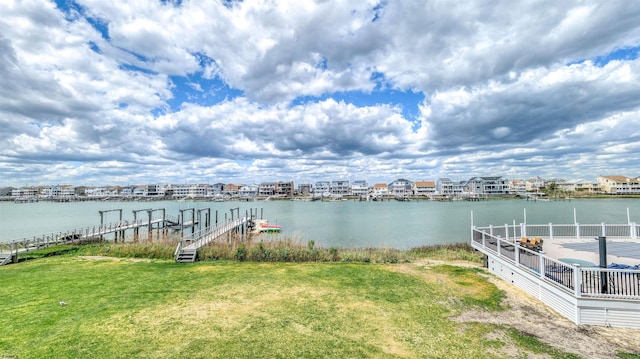 dock area featuring a water view and a yard