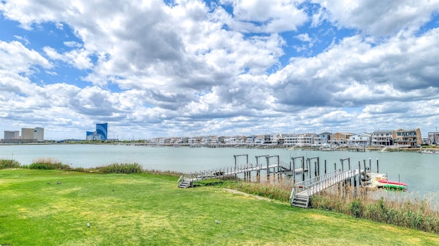 dock area featuring a water view and a yard