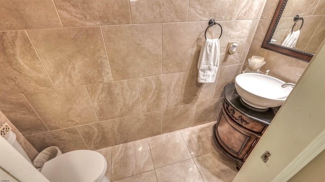 half bathroom featuring vanity, toilet, and tile patterned flooring