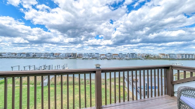 wooden deck featuring a water view and a yard