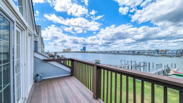 deck featuring a water view and a lawn
