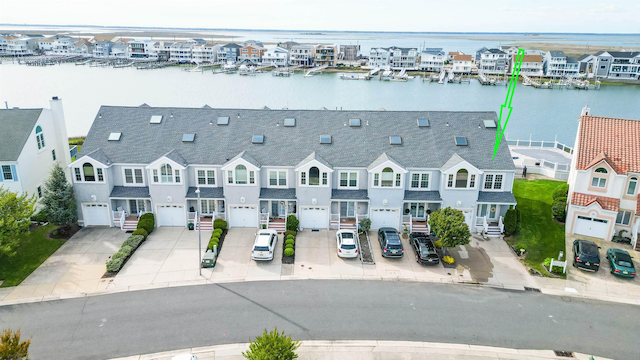 aerial view of residential area featuring a large body of water