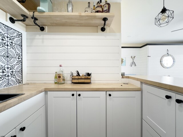 kitchen featuring wood counters, white cabinetry, and open shelves