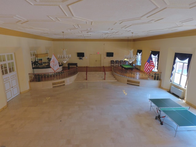 below grade area featuring a chandelier, tile patterned floors, and baseboards