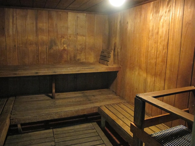 relaxing sauna / steam room featuring wood walls