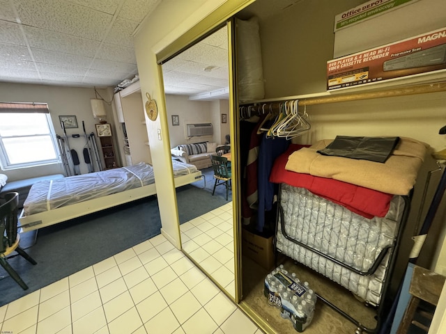 bedroom with a paneled ceiling and carpet floors