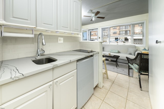 kitchen featuring backsplash, a ceiling fan, white cabinetry, a sink, and light tile patterned flooring