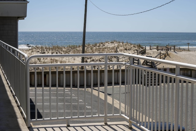 balcony featuring view of water and beach