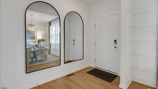 foyer featuring light wood-style flooring and baseboards