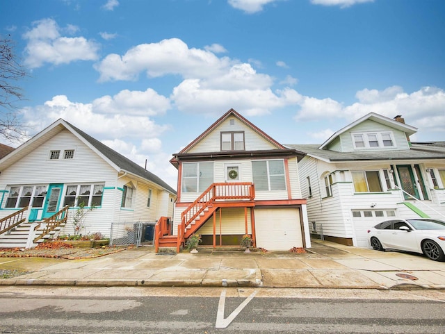 14 N Hillside Ave, Ventnor, NJ 08406 - view of front of house with stairs, concrete driveway, an attached garage, and a gate