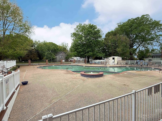 550 Central Avenue G-14Constitution Ct, Linwood, NJ 08221 - view of pool with a patio, fence, a pool with connected hot tub, an outdoor structure, and a storage unit