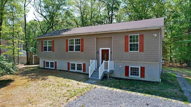 928 S Mill, Vineland, NJ 08360 - raised ranch featuring stucco siding, a shingled roof, and view of wooded area
