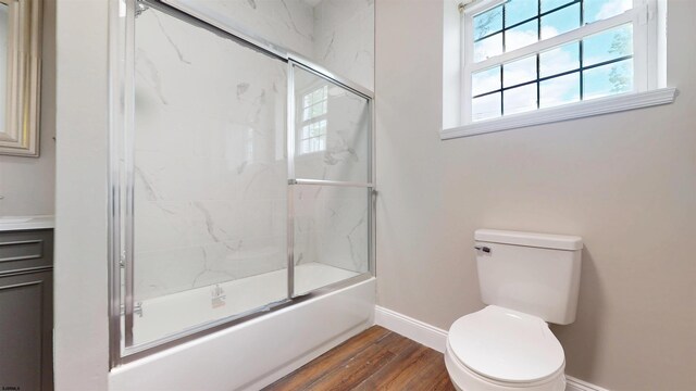 928 S Mill, Vineland, NJ 08360 - bathroom with baseboards, wood finished floors, toilet, shower / bath combination with glass door, and vanity