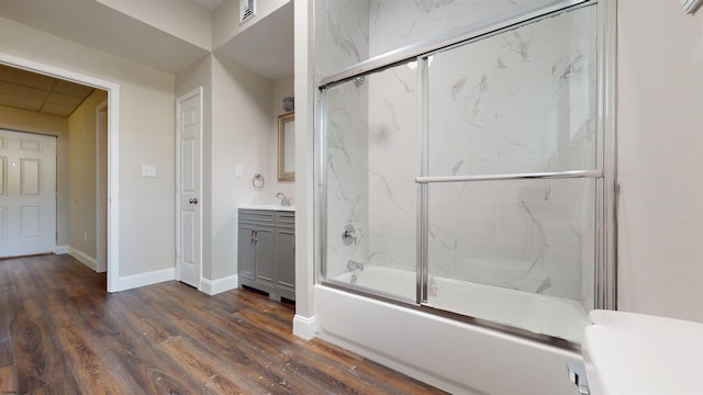 928 S Mill, Vineland, NJ 08360 - bathroom with bath / shower combo with glass door, wood finished floors, baseboards, and vanity