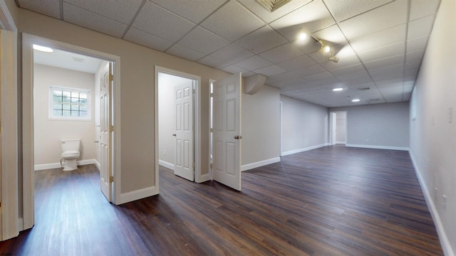 928 S Mill, Vineland, NJ 08360 - basement featuring a drop ceiling, dark wood-style floors, and baseboards