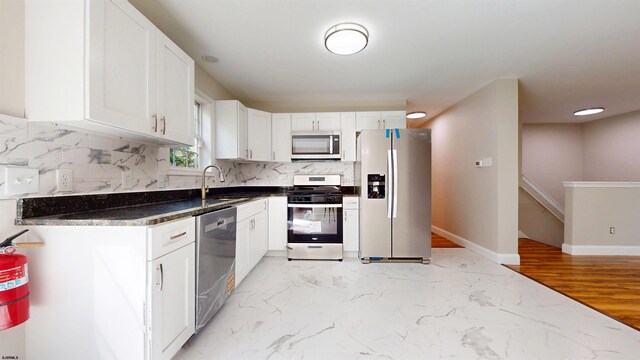 928 S Mill, Vineland, NJ 08360 - kitchen with stainless steel appliances, a sink, tasteful backsplash, and white cabinetry