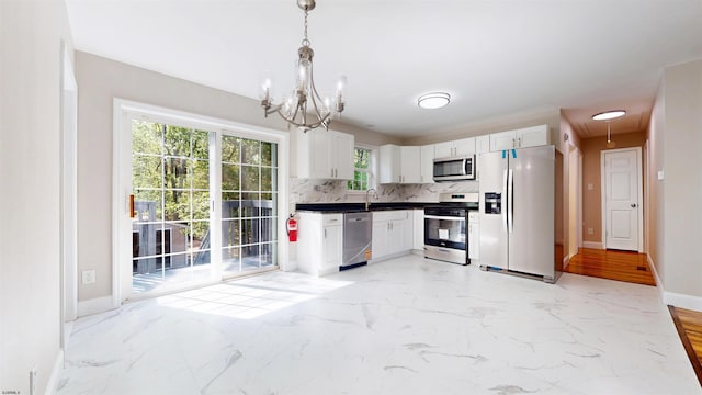 928 S Mill, Vineland, NJ 08360 - kitchen with stainless steel appliances, tasteful backsplash, dark countertops, a chandelier, and healthy amount of natural light