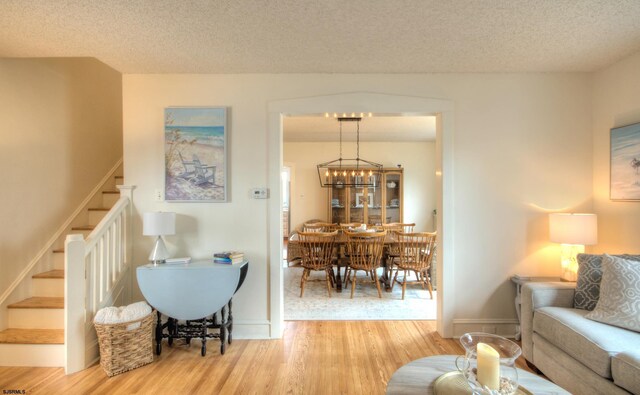 15 N Douglas Ave, Margate, NJ 08402 - living area with wood finished floors, stairway, a textured ceiling, and baseboards