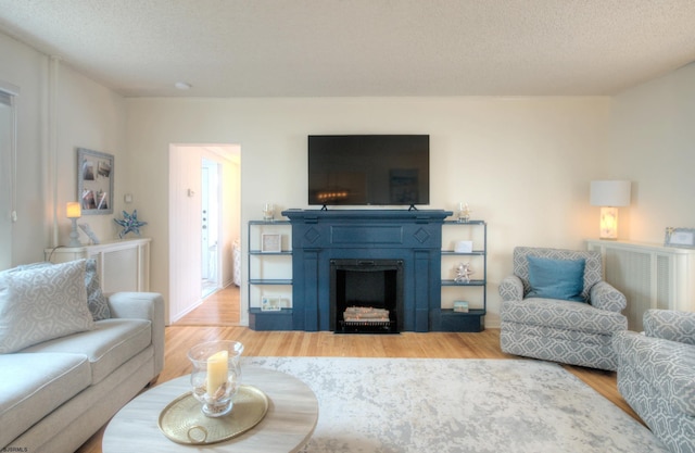 15 N Douglas Ave, Margate, NJ 08402 - living area with light wood-style floors, a fireplace, and a textured ceiling
