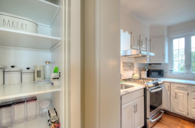 15 N Douglas Ave, Margate, NJ 08402 - kitchen featuring stainless steel gas range oven, black microwave, under cabinet range hood, and white cabinetry