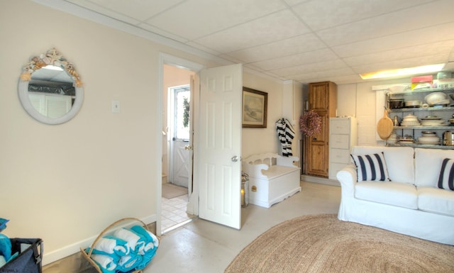 15 N Douglas Ave, Margate, NJ 08402 - living area with finished concrete floors, a drop ceiling, and baseboards