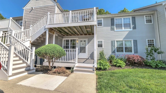 view of front of property featuring stairway and covered porch