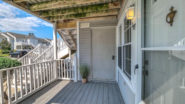 wooden deck with a residential view and stairway
