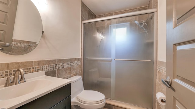 31 English Ln, Egg Harbor Township, NJ 08234 - bathroom featuring tile walls, toilet, a shower stall, vanity, and wainscoting