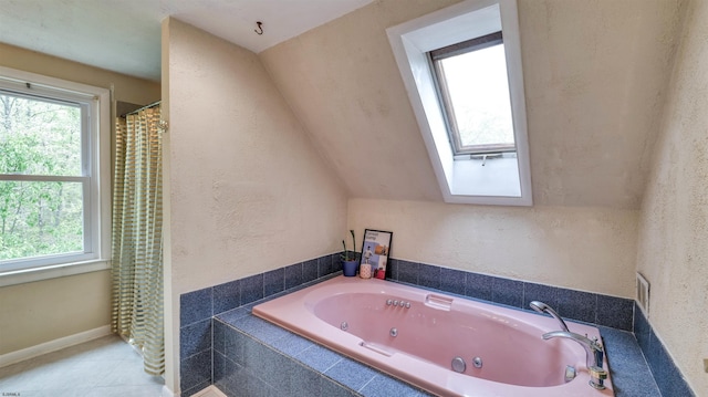 31 English Ln, Egg Harbor Township, NJ 08234 - bathroom with a tub with jets, tile patterned floors, a skylight, and a textured wall