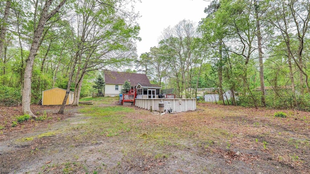 31 English Ln, Egg Harbor Township, NJ 08234 - view of yard featuring a storage unit, an outbuilding, and a deck
