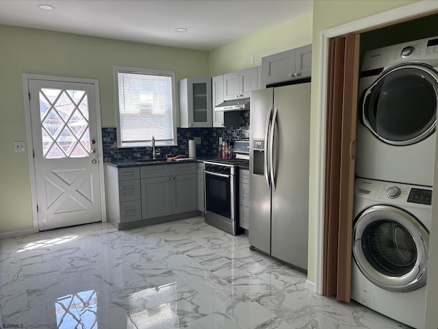 2910 Sunset Ave, Atlantic City, NJ 08401 - kitchen featuring appliances with stainless steel finishes, stacked washer / drying machine, dark countertops, gray cabinetry, and a sink