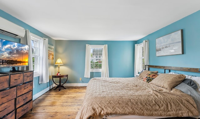 1224 Front St, Mauricetown, NJ 08329 - bedroom with hardwood / wood-style floors, baseboards, and a wall mounted AC