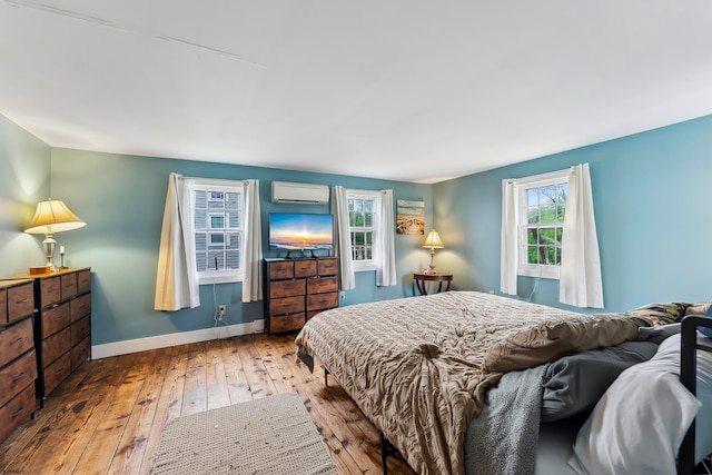 1224 Front St, Mauricetown, NJ 08329 - bedroom with wood-type flooring, a wall unit AC, and baseboards