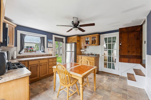 1224 Front St, Mauricetown, NJ 08329 - kitchen featuring freestanding refrigerator, a sink, ceiling fan, glass insert cabinets, and brown cabinets