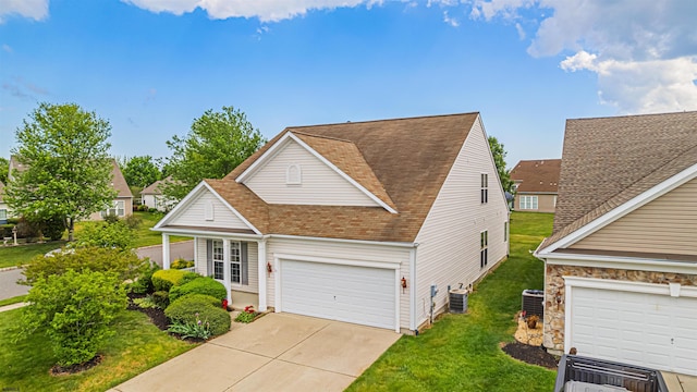 31 Leah Ct, Hammonton, NJ 08037 - traditional home featuring a front yard, concrete driveway, a garage, roof with shingles, and central AC