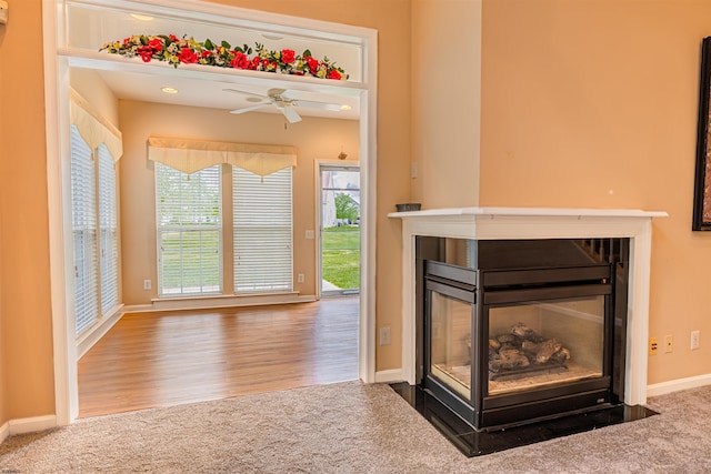 31 Leah Ct, Hammonton, NJ 08037 - unfurnished living room featuring a multi sided fireplace, ceiling fan, carpet, baseboards, and wood finished floors