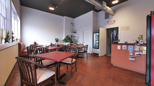 9402 Ventnor Ave, Margate, NJ 08402 - dining room featuring a towering ceiling and concrete flooring