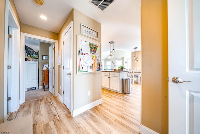 802 Coolidge Rd Unit 2, Ocean City, NJ 08226 - corridor with light wood-type flooring, a chandelier, and baseboards