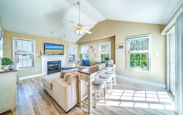 802 Coolidge Rd Unit 2, Ocean City, NJ 08226 - living area featuring light wood-style flooring, baseboards, vaulted ceiling, a glass covered fireplace, and ceiling fan