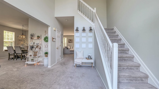 223 Churchill Dr, Egg Harbor Township, NJ 08234 - staircase with carpet floors, a high ceiling, baseboards, and a chandelier