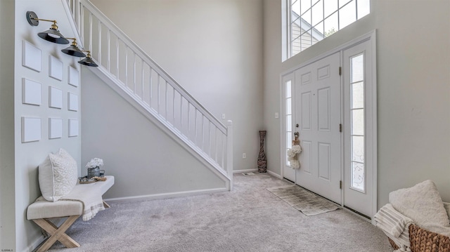 223 Churchill Dr, Egg Harbor Township, NJ 08234 - carpeted foyer entrance with a towering ceiling, stairway, and baseboards