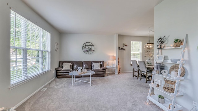 223 Churchill Dr, Egg Harbor Township, NJ 08234 - carpeted living area featuring baseboards and a chandelier