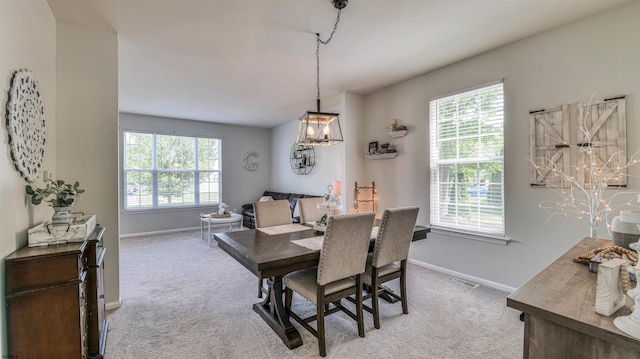 223 Churchill Dr, Egg Harbor Township, NJ 08234 - carpeted dining space with healthy amount of natural light, baseboards, and a chandelier