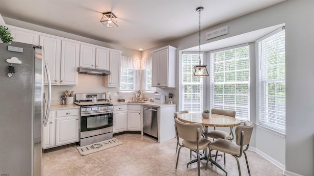 223 Churchill Dr, Egg Harbor Township, NJ 08234 - kitchen featuring stainless steel appliances, under cabinet range hood, a sink, light countertops, and white cabinets