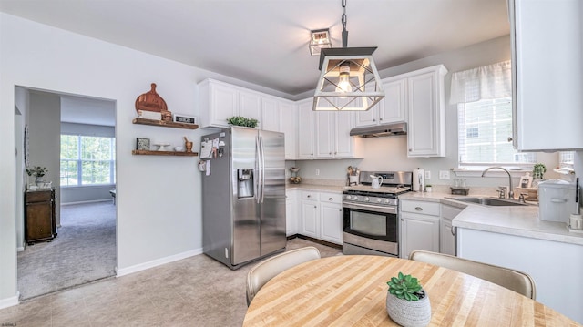 223 Churchill Dr, Egg Harbor Township, NJ 08234 - kitchen with stainless steel appliances, under cabinet range hood, a sink, light countertops, and white cabinetry