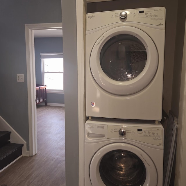 206 N S Carolina Ave, Atlantic City, NJ 08401 - laundry area with stacked washer and clothes dryer, baseboards, and wood finished floors