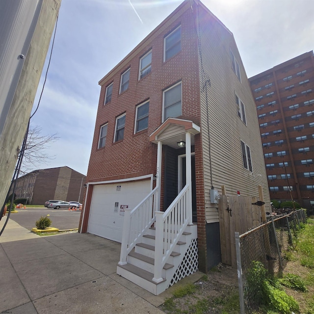 206 N S Carolina Ave, Atlantic City, NJ 08401 - view of front of home with concrete driveway, a garage, and fence