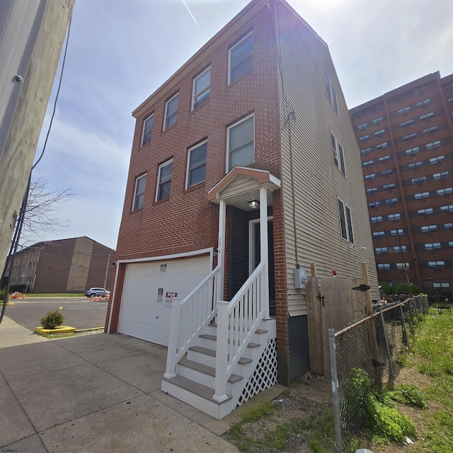 206 N S Carolina Ave, Atlantic City, NJ 08401 - view of front of house with concrete driveway, a garage, and fence
